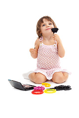 Image showing Charming little girl with makeup and colored beads in the studio