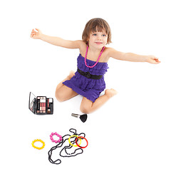 Image showing Cute little girl with makeup, necklaces and bracelets is in adul