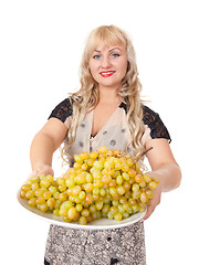 Image showing Portrait of attractive young woman holding bowl of grapes