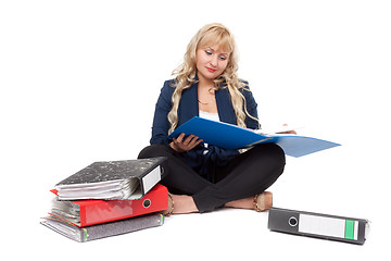 Image showing Beautiful girl sitting on the floor with folders for documents