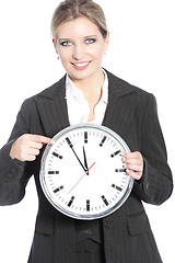 Image showing Smiling businesswoman holding a clock