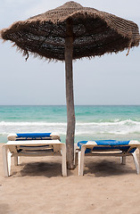 Image showing Two chaise longes on the beach