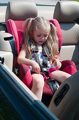 Image showing Little cute girl sitting in car seat