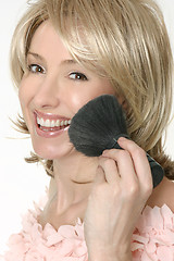 Image showing Female holding a large powder brush