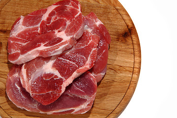 Image showing raw meat steak on the wooden board 