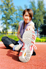 Image showing woman doing stretching exercise in park