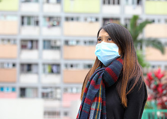 Image showing Woman wearing medical face mask in crowded city