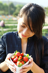 Image showing smile girl with bowl of strawberry