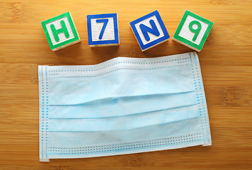 Image showing H7N9 alphabet block with protective face mask