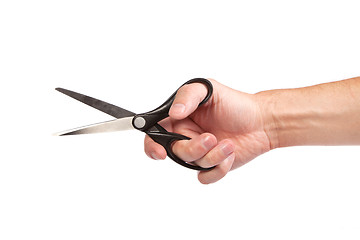 Image showing Hand is holding scissors isolated