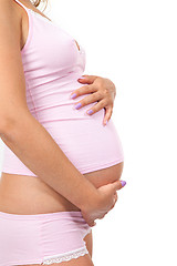 Image showing Pregnant woman is caressing her belly