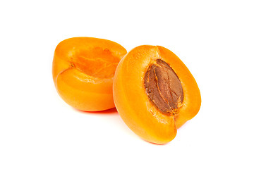 Image showing Two ripe apricot sectioned by knife