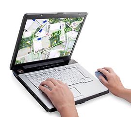 Image showing Open laptop with money