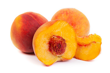 Image showing Three tasty juicy peaches on a white background