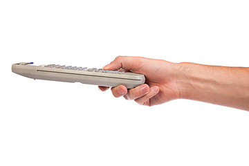 Image showing A hand holding a remote control isolated