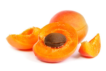 Image showing Two ripe apricot sectioned by knife