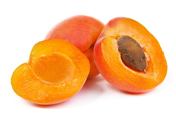 Image showing Two ripe apricot sectioned by knife