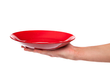 Image showing Red kitchen plate on a hand isolated