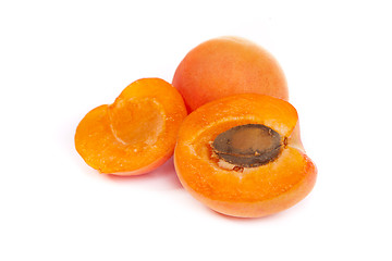 Image showing Apricots. Group of ripe apricots with a half sectioned by knife