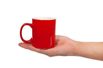 Image showing Male hand is holding a red cup