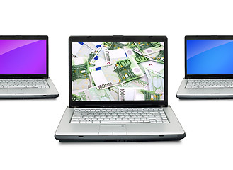 Image showing Open laptops with money