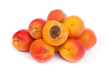 Image showing Group of ripe apricots with a half