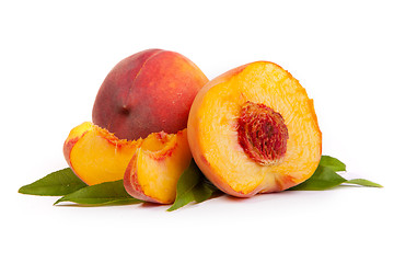 Image showing Two tasty juicy peaches with a half and slices  on a white backg