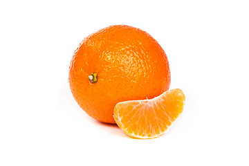 Image showing Ripe tangerine or mandarin with slices on white