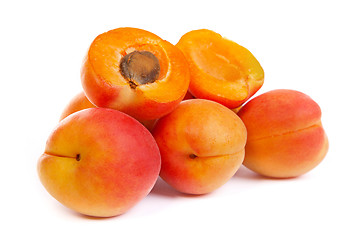 Image showing Group of ripe apricots with a half