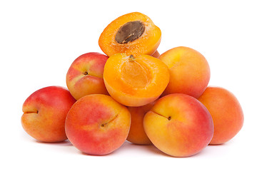 Image showing Group of ripe apricots with a half