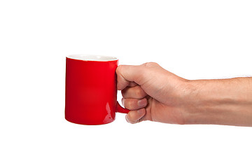 Image showing Male hand is holding a red cup