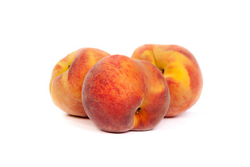 Image showing Three tasty juicy peaches on a white background