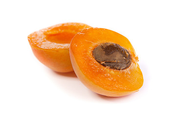 Image showing Two ripe apricot sectioned by knife