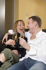 Image showing couple sitting on black couch