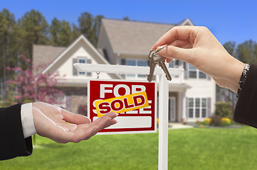 Image showing Agent Handing Over the House Keys in Front of New Home