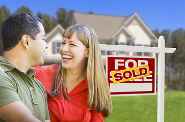 Image showing Couple in Front of Sold Real Estate Sign and House