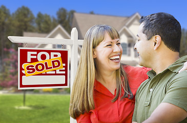 Image showing Couple in Front of Sold Real Estate Sign and House