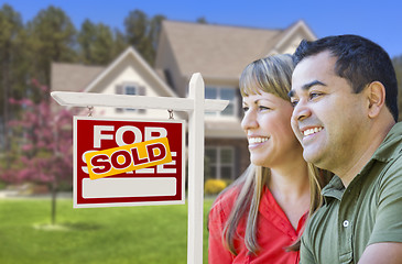 Image showing Couple in Front of Sold Real Estate Sign and House