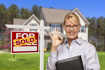 Image showing Real Estate Agent in Front of Sold Sign and House