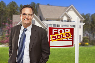 Image showing Male Real Estate Agent in Front of Sold Sign and House