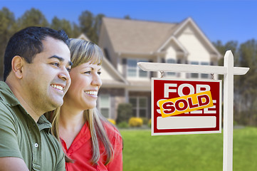 Image showing Couple in Front of Sold Real Estate Sign and House