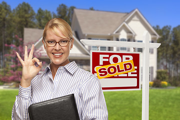 Image showing Real Estate Agent in Front of Sold Sign and House