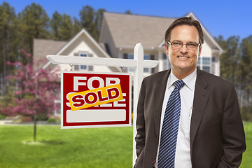 Image showing Male Real Estate Agent in Front of Sold Sign and House