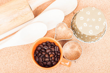 Image showing Cup of coffee bean and bakery equipment on table