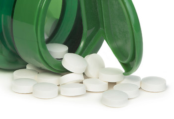 Image showing White pills and a container