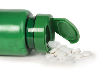 Image showing White pills and a container
