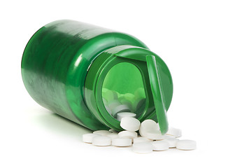 Image showing White pills and a container