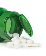 Image showing White pills and a container