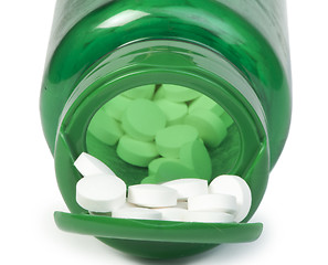 Image showing White pills and a container