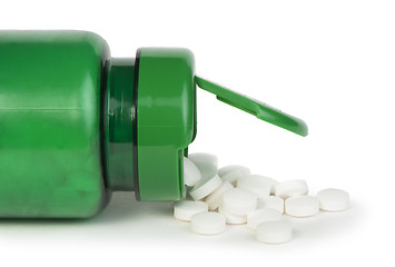 Image showing White pills and a container